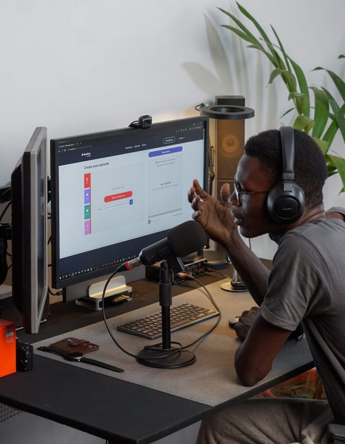 a man wearing headphones sitting in front of a computer