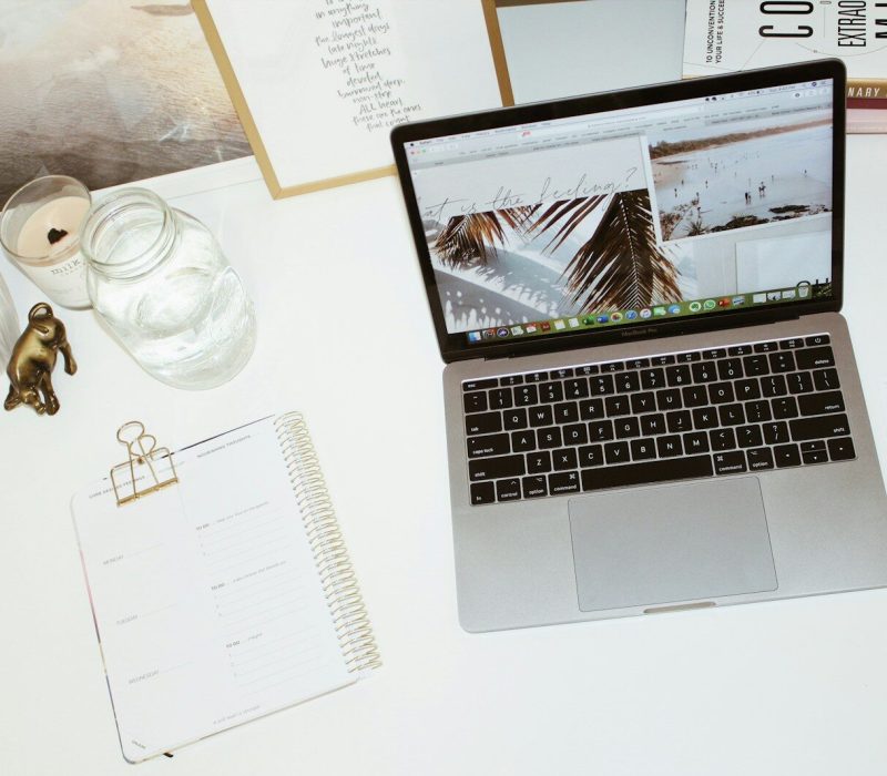 a laptop computer sitting on top of a white desk